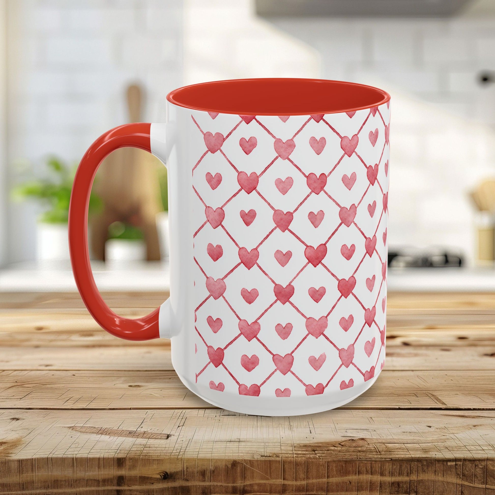 White ceramic mug with red interior and handle, featuring a watercolor geometric heart pattern.