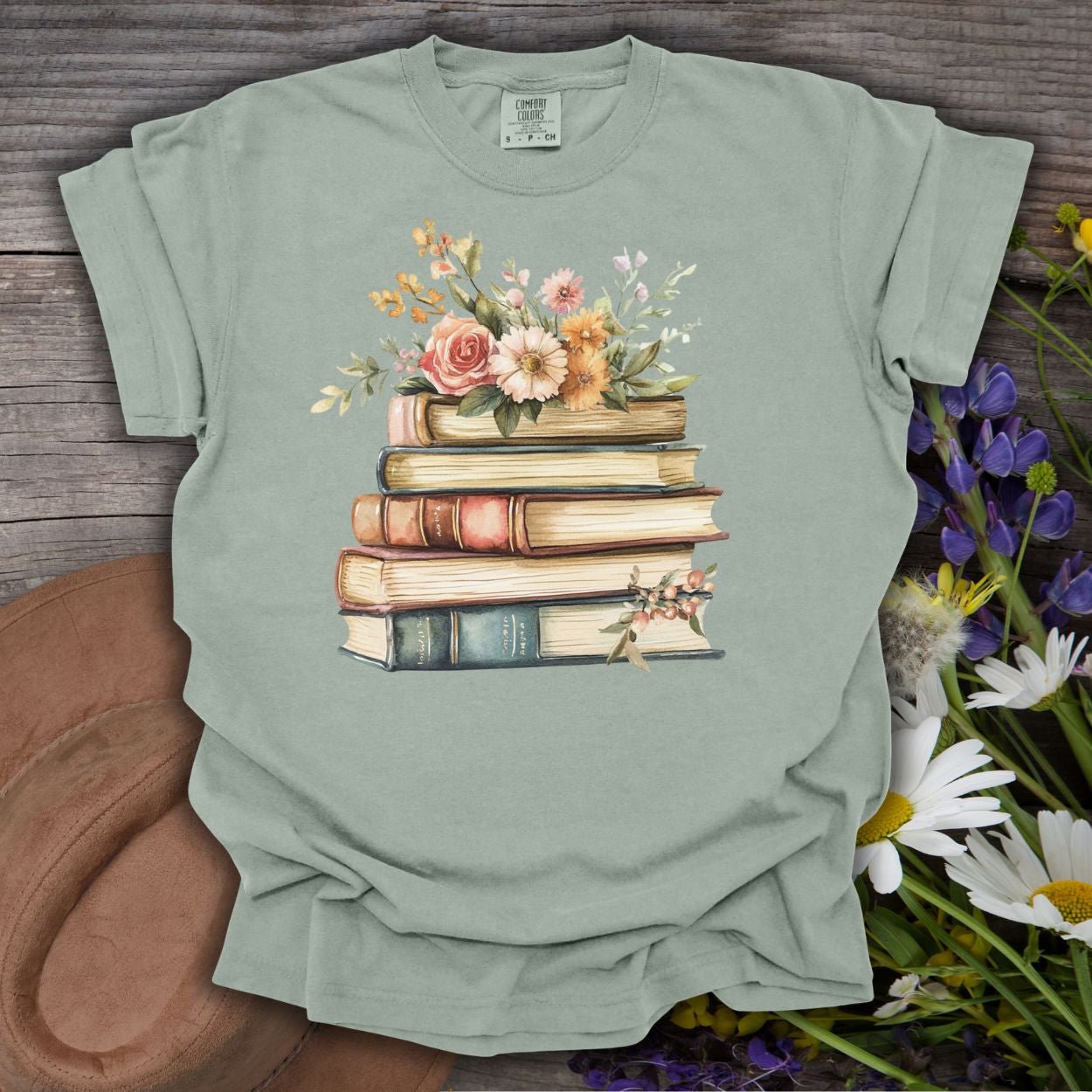 Bay green garment-dyed t-shirt with a vintage books and wildflowers graphic.