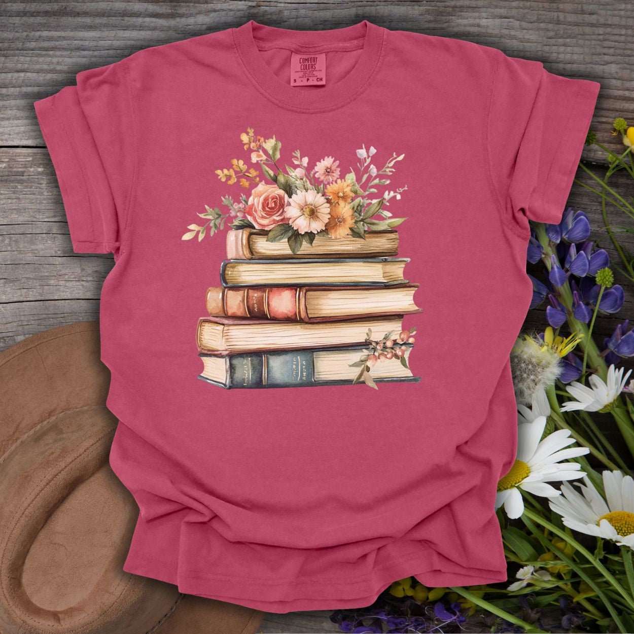 Brick red garment-dyed t-shirt with a vintage books and wildflowers graphic.