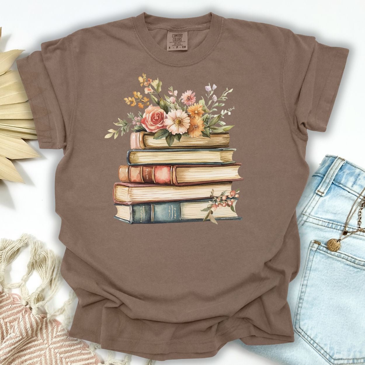 Espresso S t-shirt with a vintage stack of books and wildflowers print.