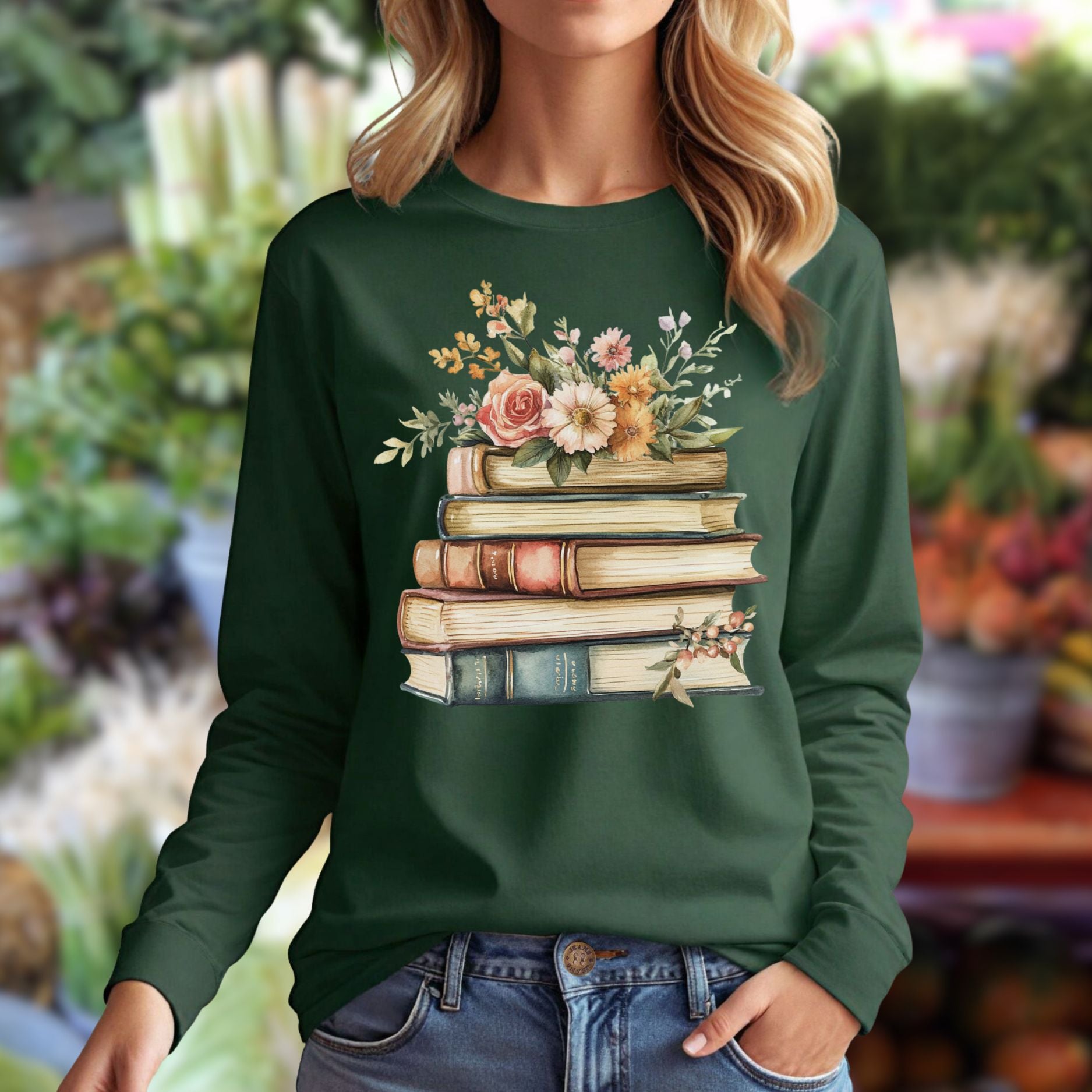 Dark green long sleeve tee with a vintage-style stack of books blooming with delicate flowers across the chest.