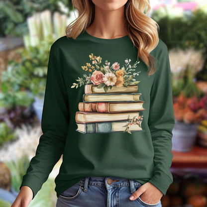 Dark green long sleeve tee with a vintage-style stack of books blooming with delicate flowers across the chest.