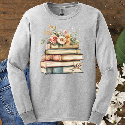 Ash gray long sleeve tee with a vintage-style stack of books blooming with delicate summer flowers.