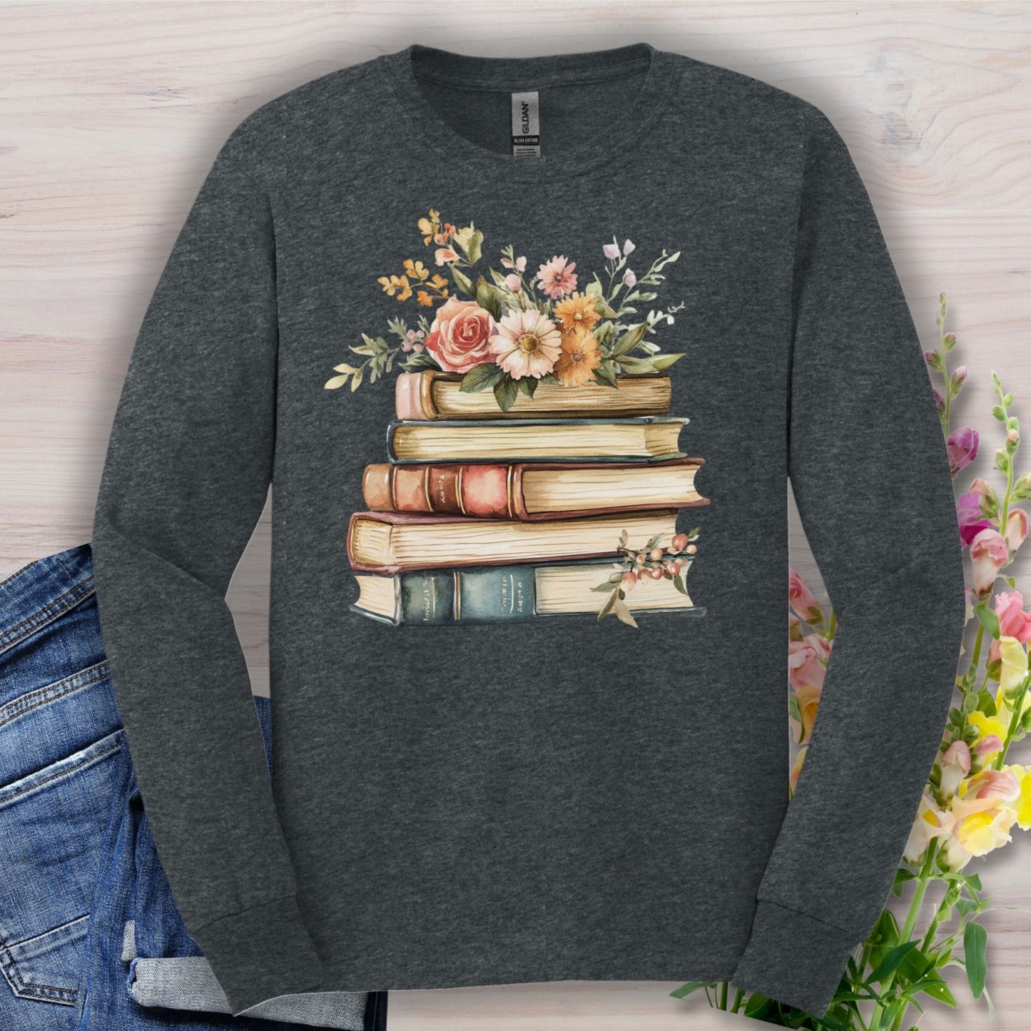 Dark Heather long sleeve tee with a vintage-feel cotton, featuring a stack of books blooming with summer flowers.