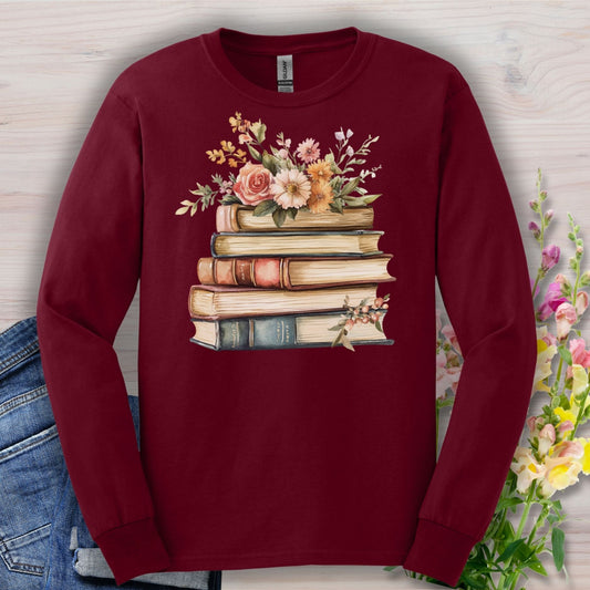 Maroon long-sleeve tee with a vintage-style stack of books and delicate summer flowers design.