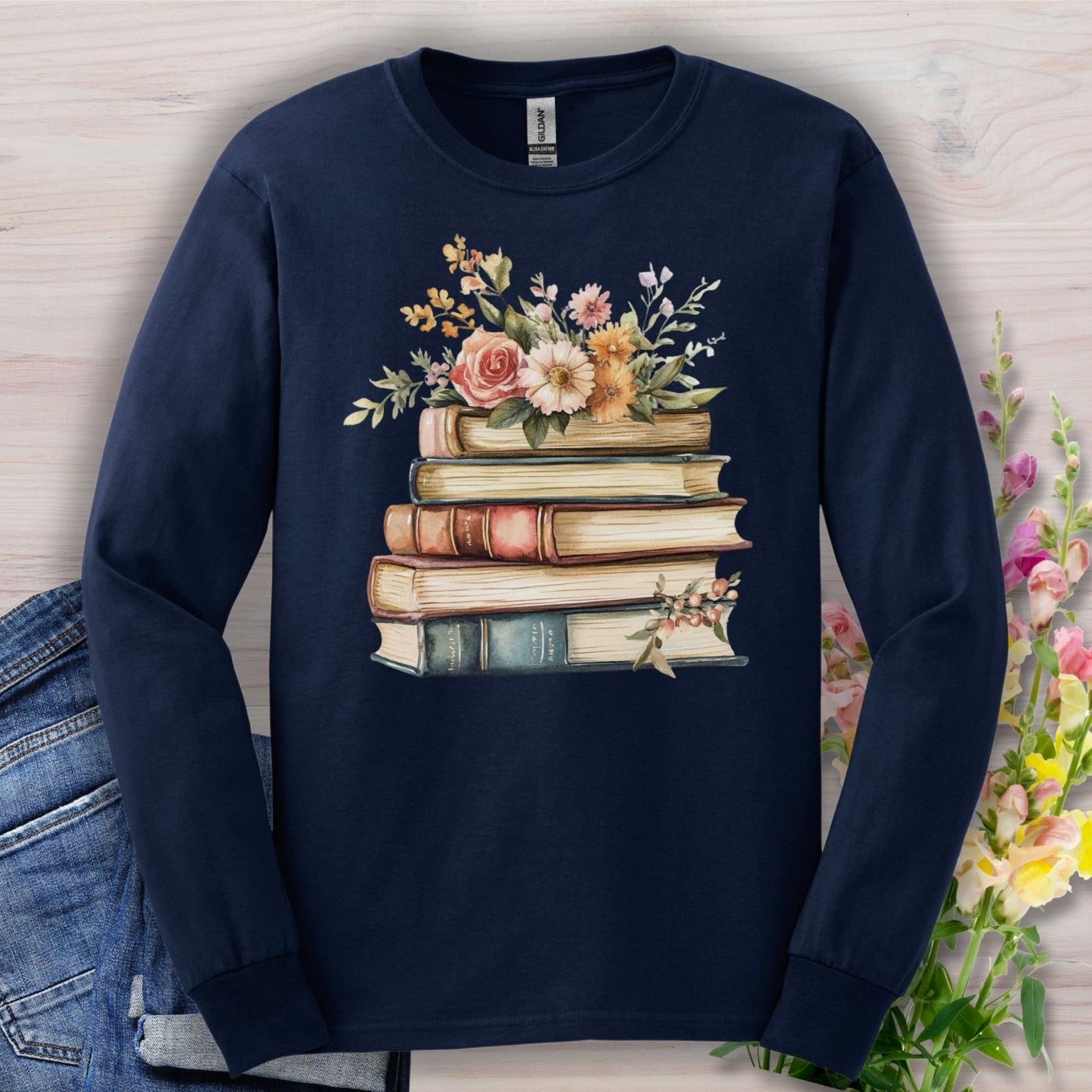 Navy long sleeve tee with a vintage book stack and delicate floral illustration.