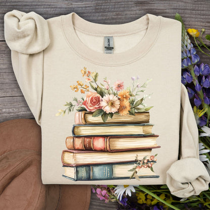 Sand unisex sweatshirt with a vintage illustration of stacked books and delicate summer flowers.