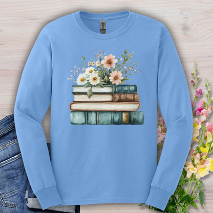 Carolina Blue long sleeve tee with a vintage stack of books and soft wildflowers.
