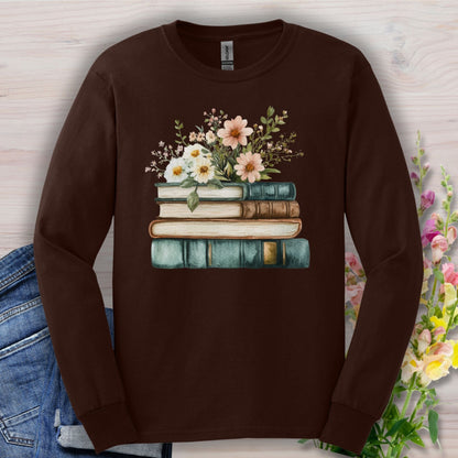 Dark chocolate long sleeve tee with a vintage stack of books and wildflowers design.