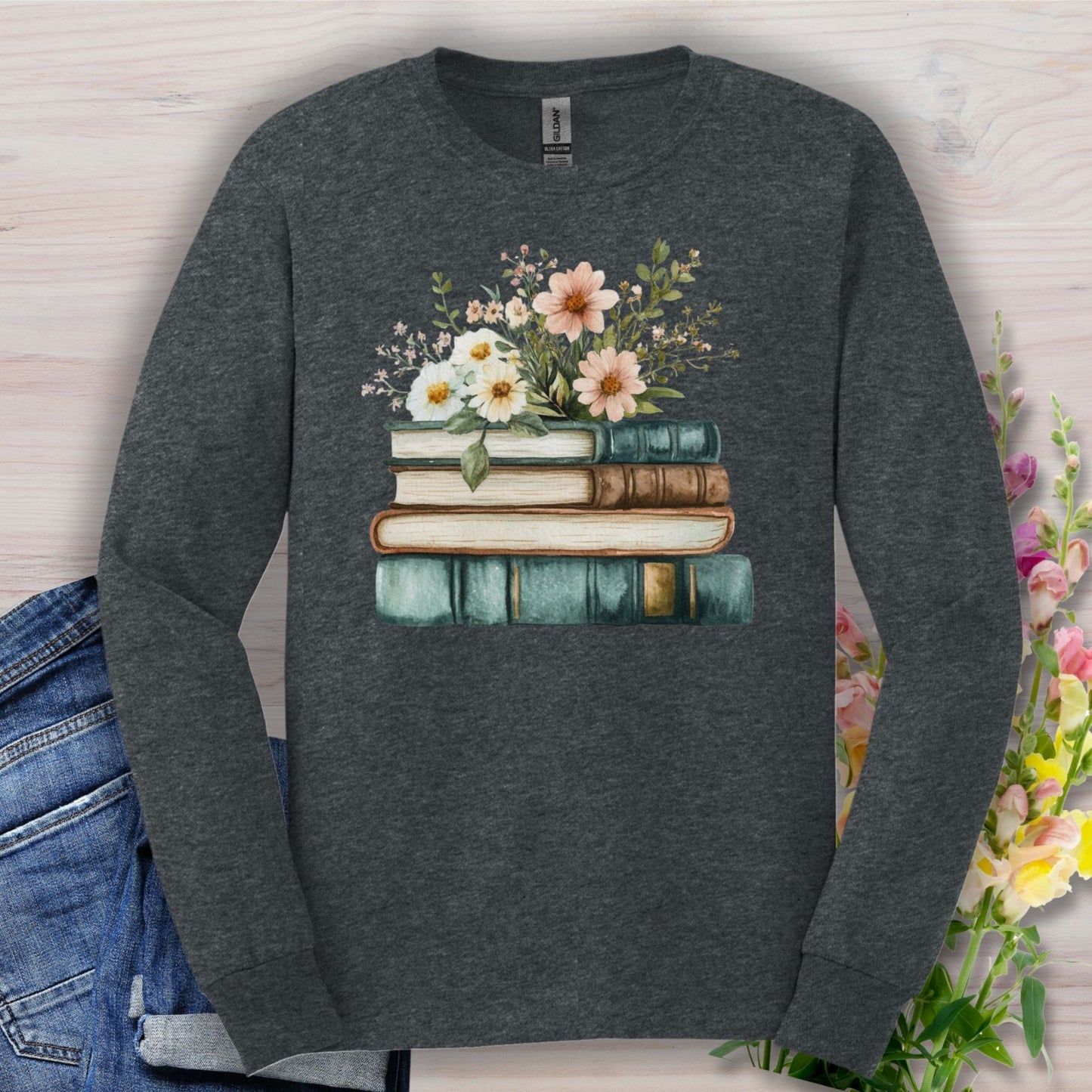 Dark heather long sleeve tee with a vintage stack of books and wildflowers print.