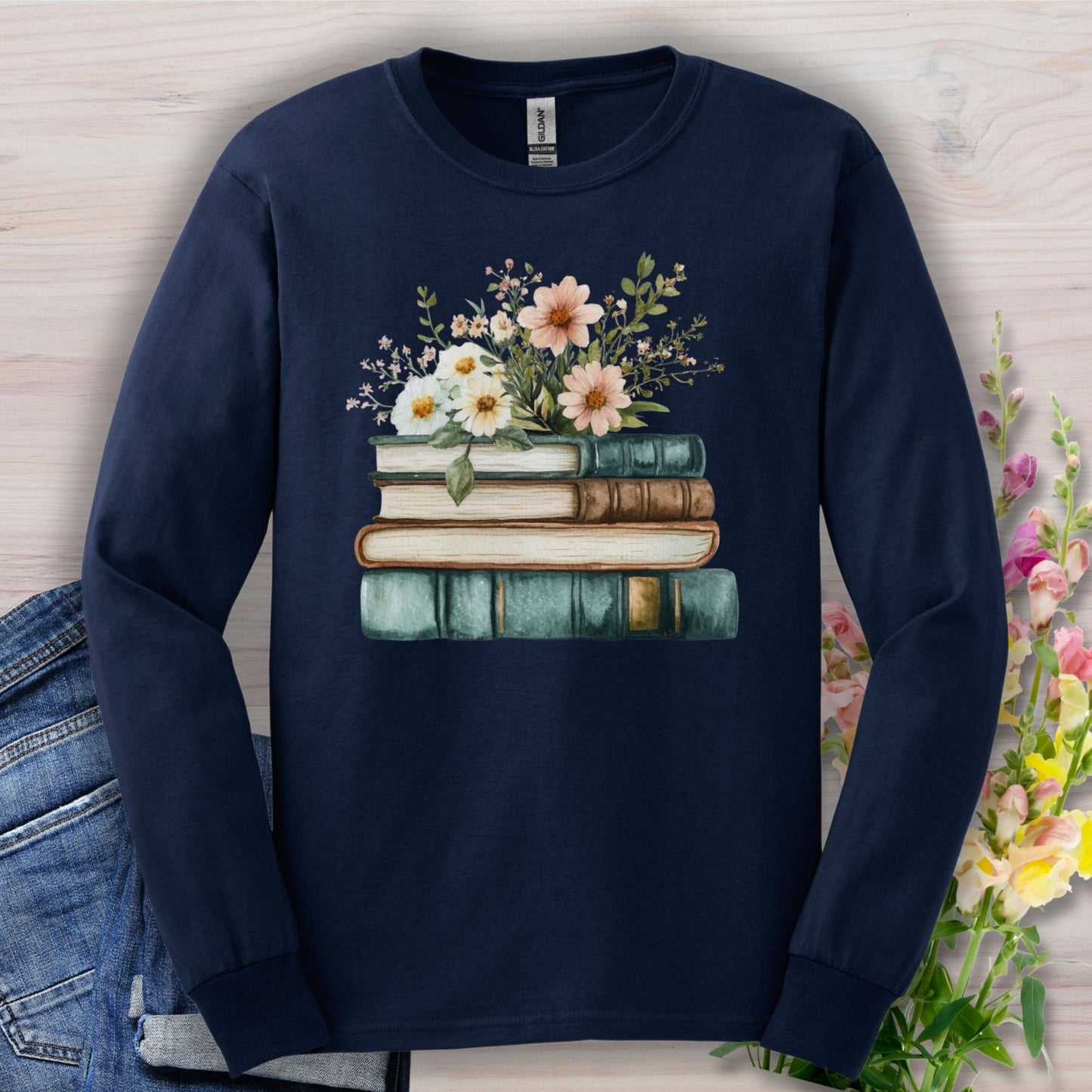 Navy long sleeve tee with a vintage stack of books and soft wildflowers print.
