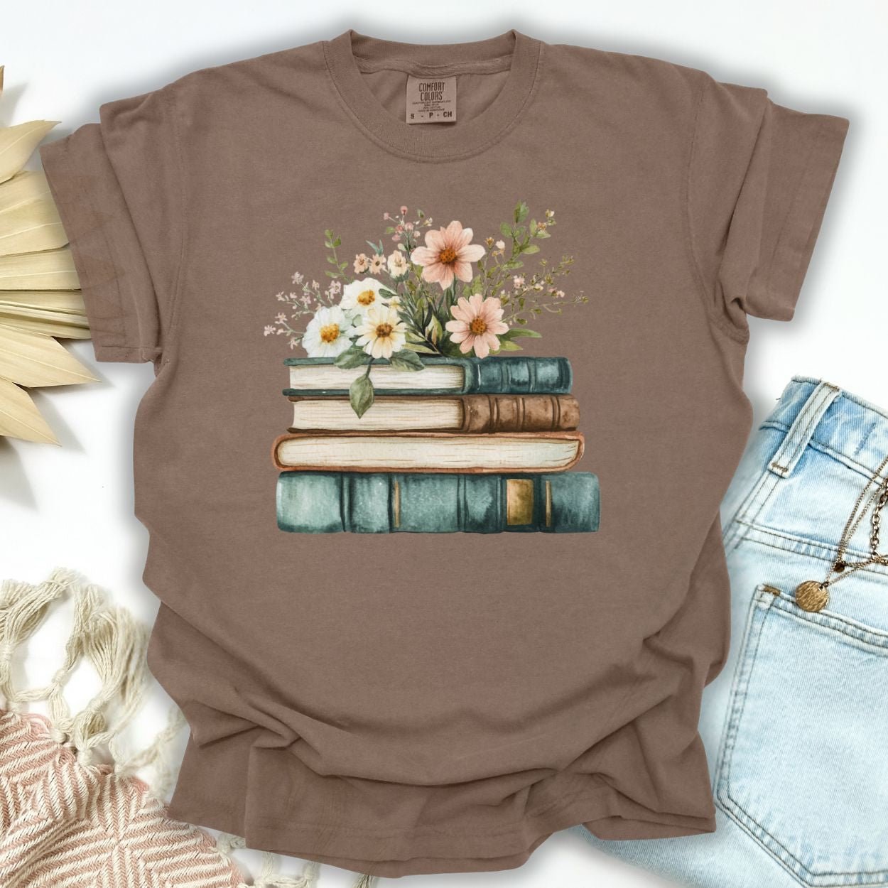 Espresso S-size garment-dyed cotton t-shirt with a stacked books and wildflowers illustration.
