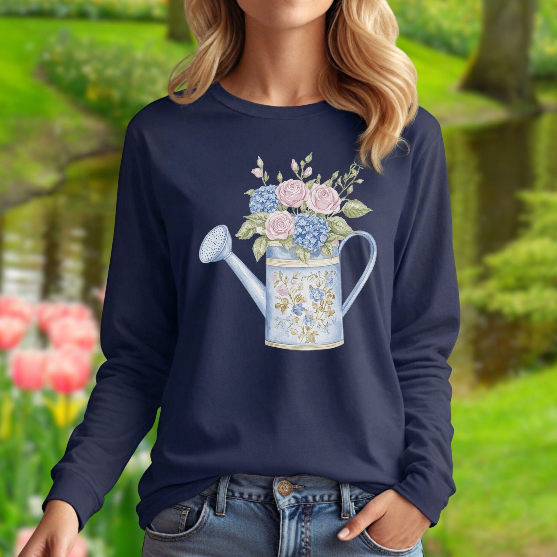Navy long sleeve tee with a watercolor vintage watering can filled with pink roses and blue hydrangeas.