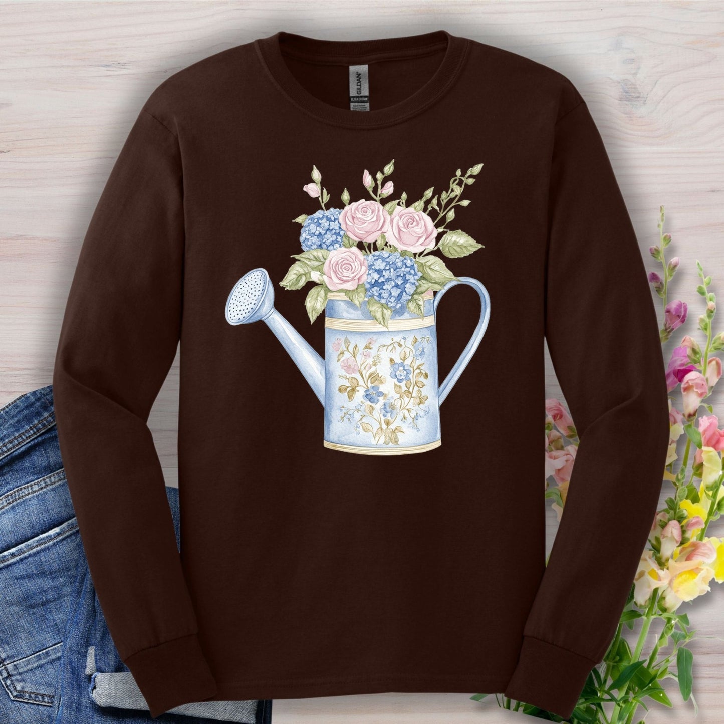 Dark Chocolate long sleeve tee with a watercolor vintage watering can and pink roses, blue hydrangeas, and greenery.