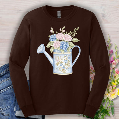 Dark Chocolate long sleeve tee with a watercolor vintage watering can and pink roses, blue hydrangeas, and greenery.
