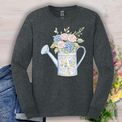 Dark Heather S long sleeve tee with a watercolor vintage watering can, pink roses, and blue hydrangeas.