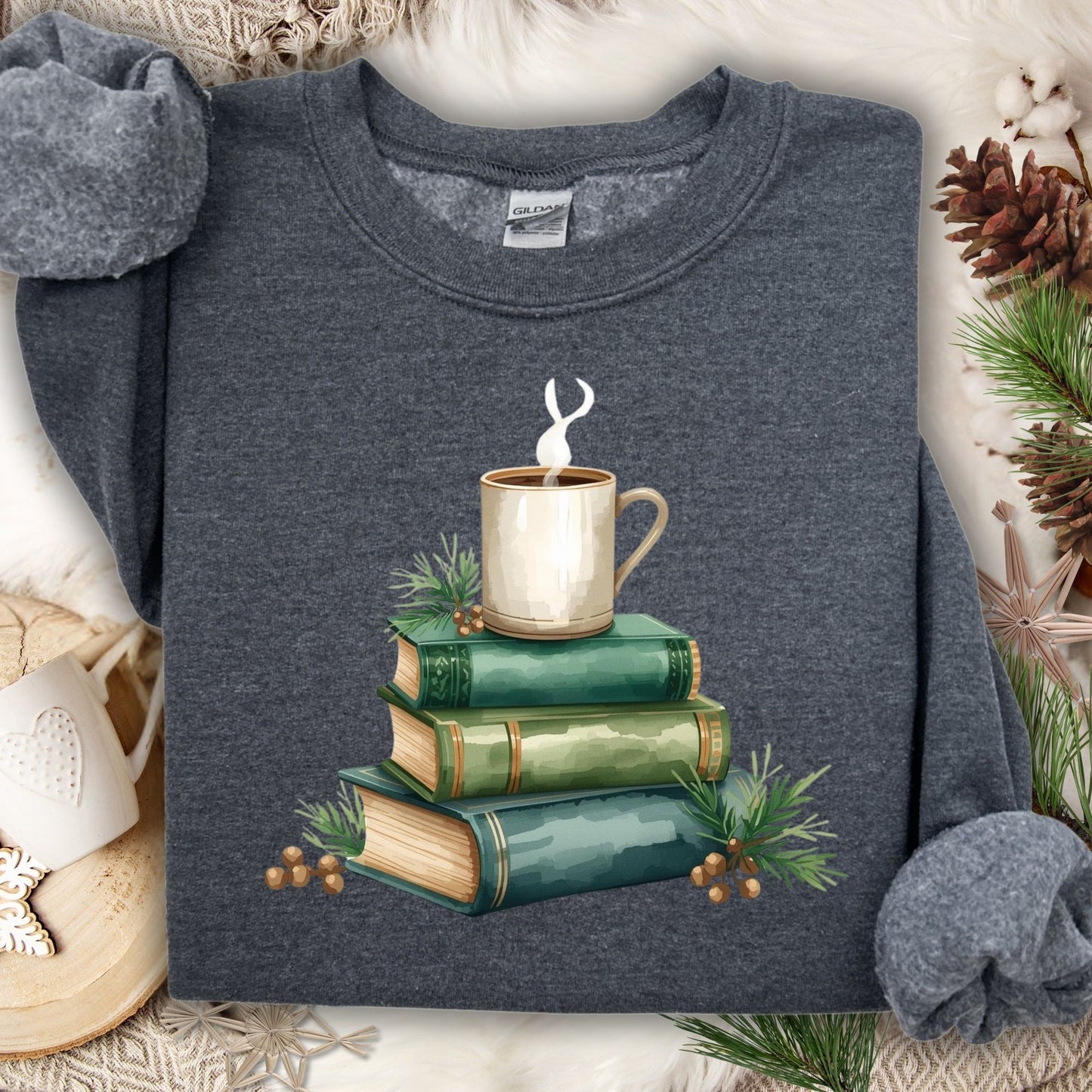 Dark gray long sleeve tee with a watercolor design of stacked vintage green books and a steaming coffee mug.