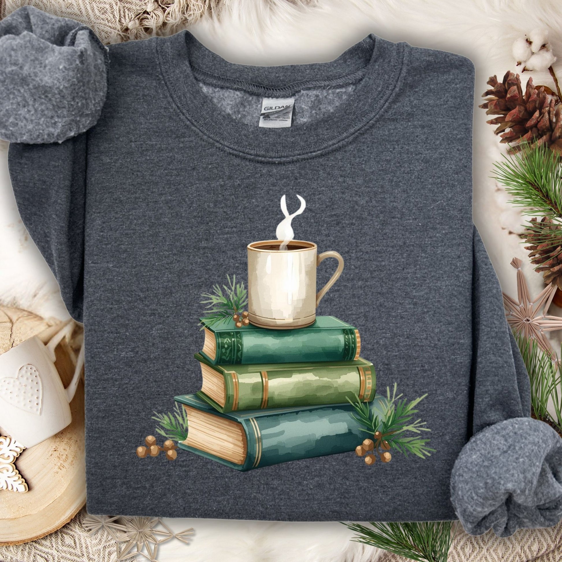 Dark gray long sleeve tee with a watercolor design of stacked vintage green books and a steaming coffee mug.