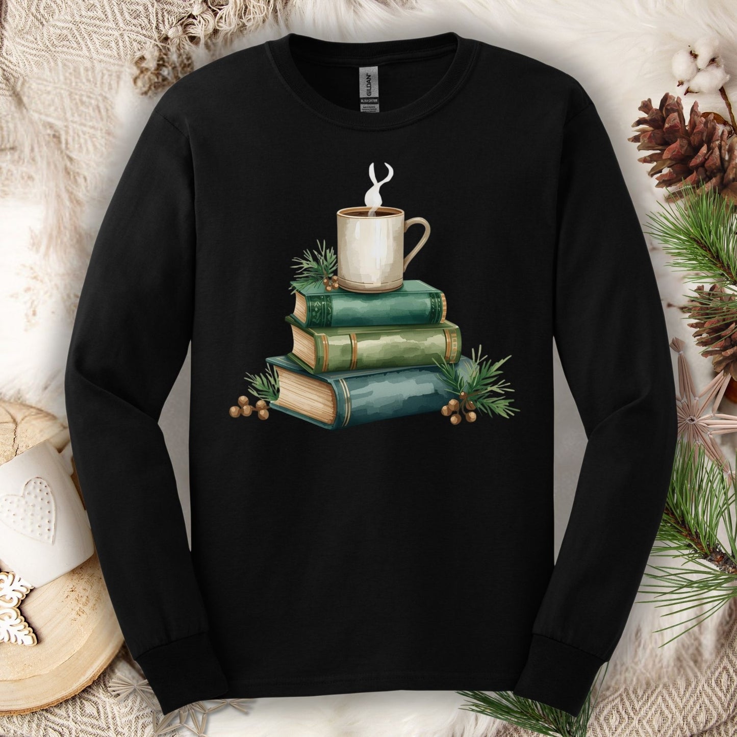 Black long sleeve tee with a watercolor design of stacked vintage green books and a steaming coffee mug.
