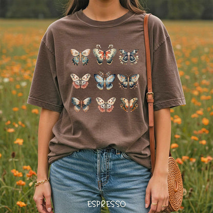 Espresso brown garment-dyed cotton t-shirt featuring a grid of vintage-style watercolor moth and butterfly illustrations.