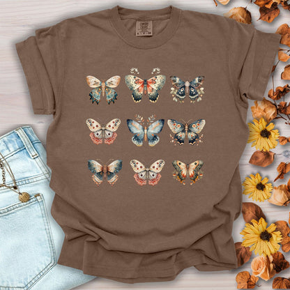 Espresso brown garment-dyed cotton t-shirt featuring a vintage watercolor grid of moths and butterflies, size small.