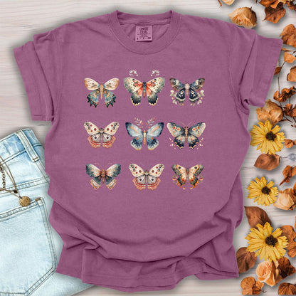 Berry-colored heavyweight cotton t-shirt featuring a vintage watercolor grid of moths and butterflies in a relaxed fit.