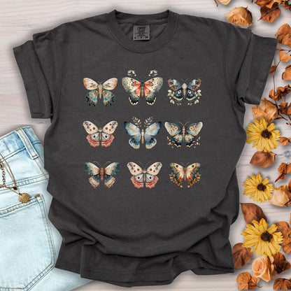 Pepper-colored, heavyweight cotton t-shirt featuring a grid of vintage watercolor moth and butterfly illustrations.