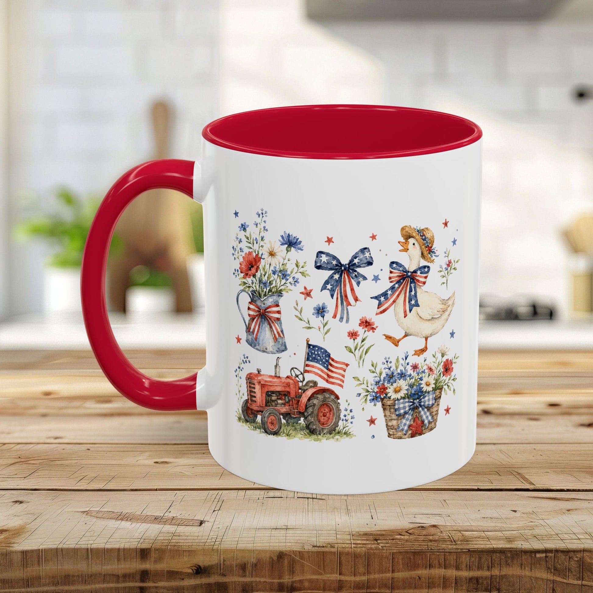 White ceramic mug with red handle and interior, featuring a patriotic farmhouse design with a goose, tractor, and wildflowers.