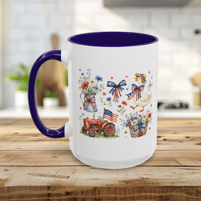 White ceramic mug with a purple handle and interior, featuring a patriotic farmhouse design with a goose, tractor, and wildflowers.