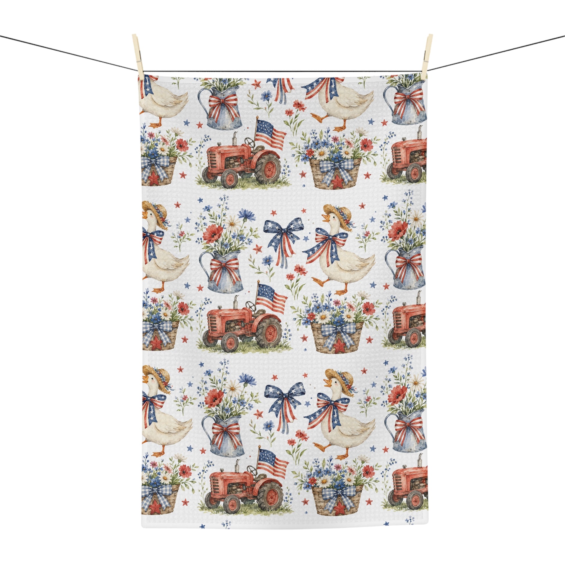 Vintage patriotic farmhouse tea towel with red tractors, geese, and floral baskets on a white microfiber ground.