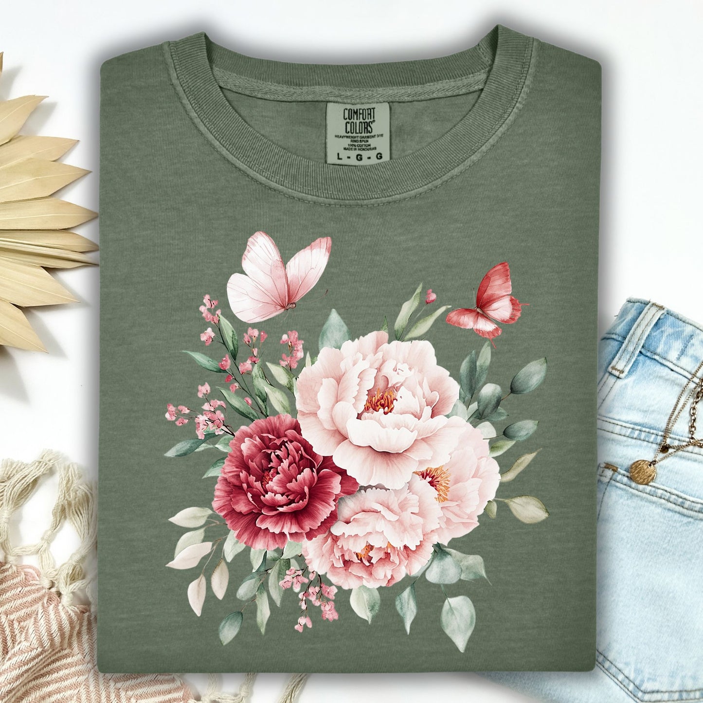 Moss green garment-dyed t-shirt with a watercolor peony and butterfly bouquet design.