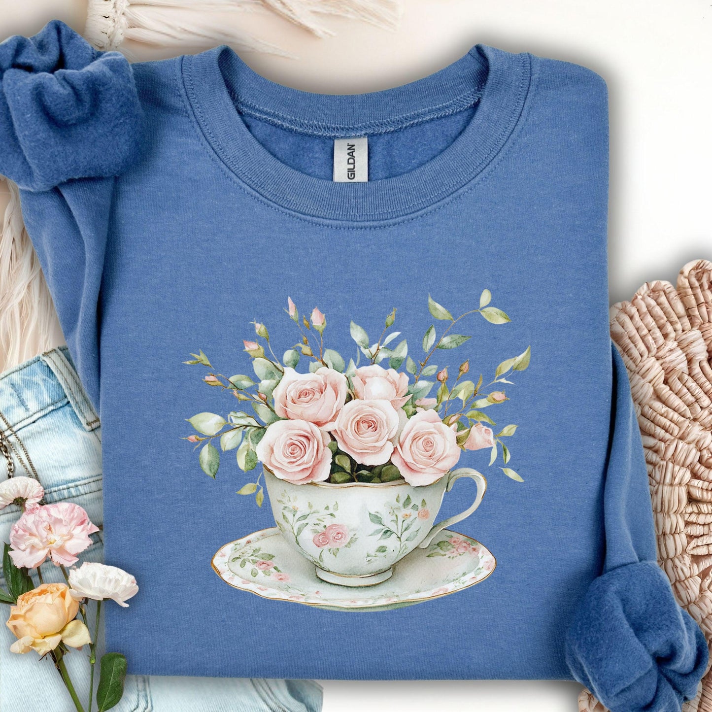 Indigo blue sweatshirt with vintage pink rose bouquet in a teacup design.