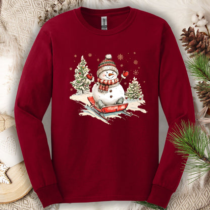 Cardinal Red Gildan long sleeve tee with a vintage snowman sledding design.