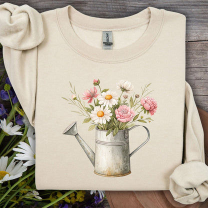 Sand S sweatshirt with a vintage watering can and watercolor daisies, peonies, and cosmos.