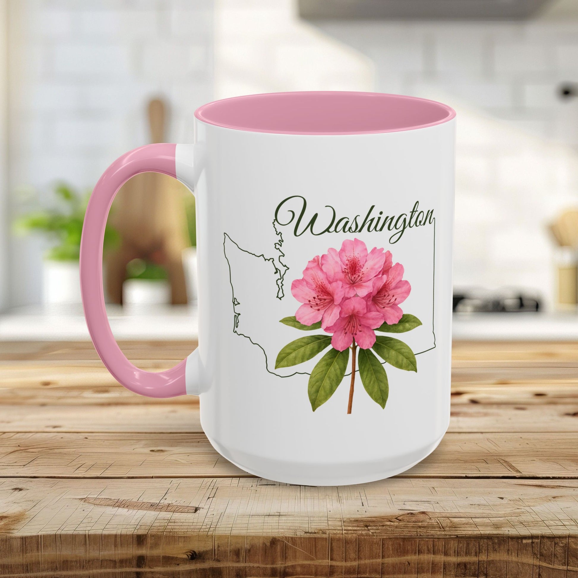 White ceramic mug with pink interior and handle, featuring a Washington state outline and pink rhododendron.