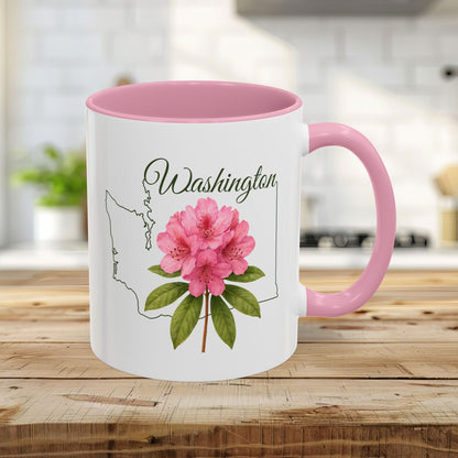 White ceramic 11oz mug with pink interior and handle, featuring a Washington state outline and a vibrant pink rhododendron.