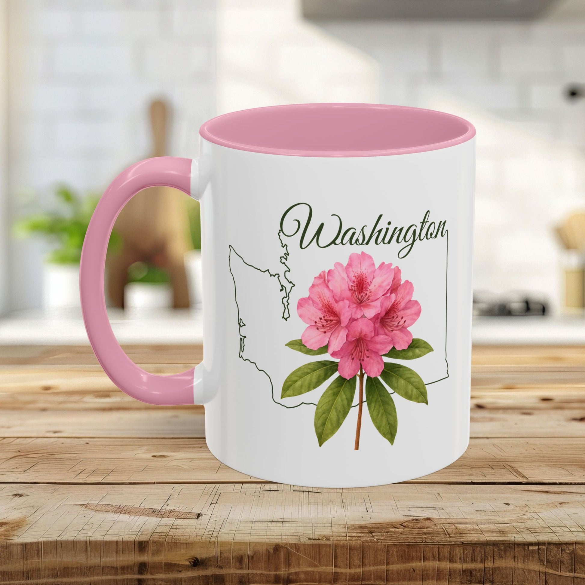 White ceramic mug with pink interior and handle, featuring a Washington state outline and pink rhododendron.