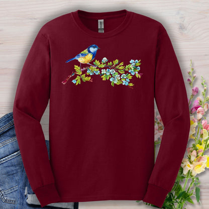 Maroon long sleeve tee with a watercolor blue bird on a budding branch design.