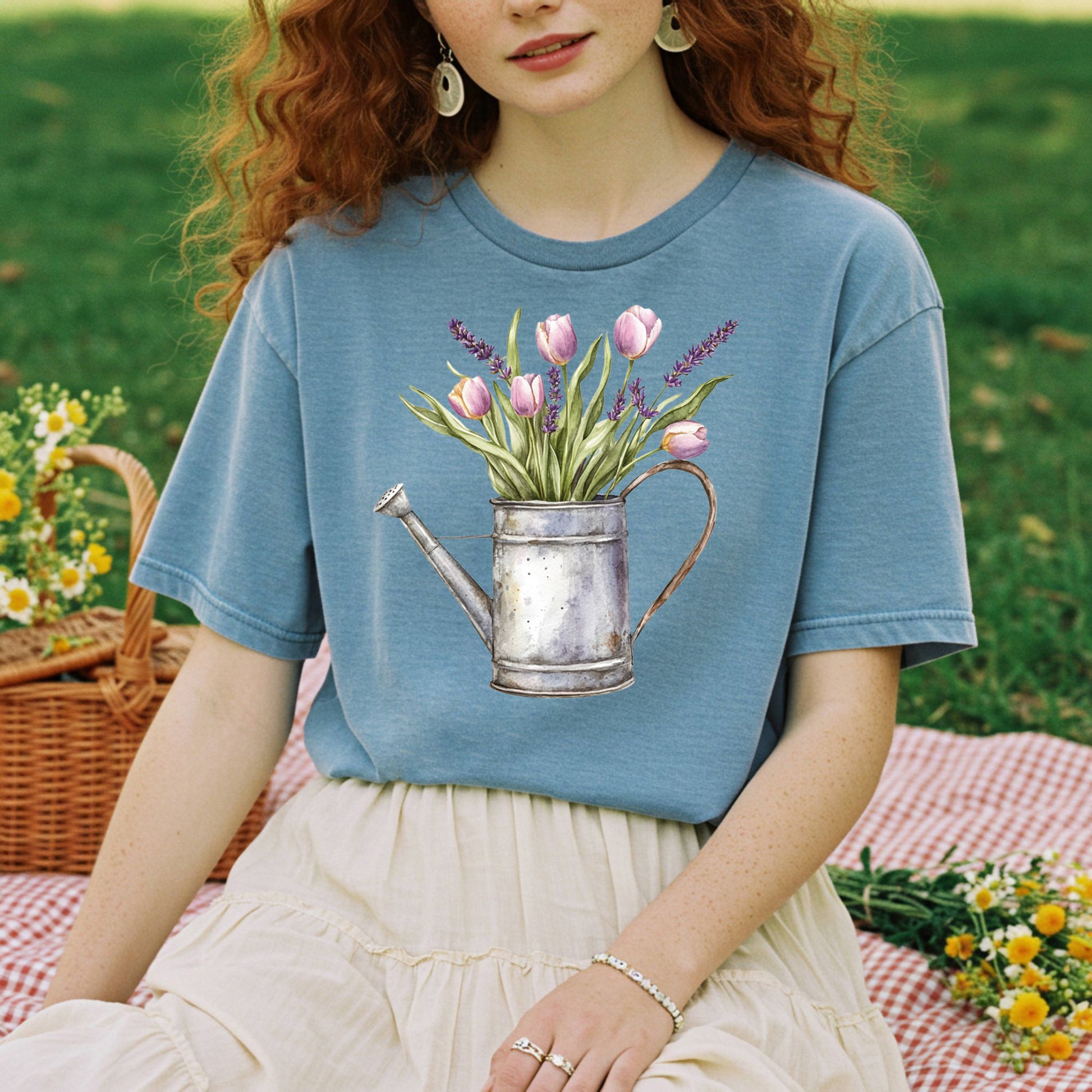 Blue t-shirt with a vintage watering can and purple tulips and lavender illustration.