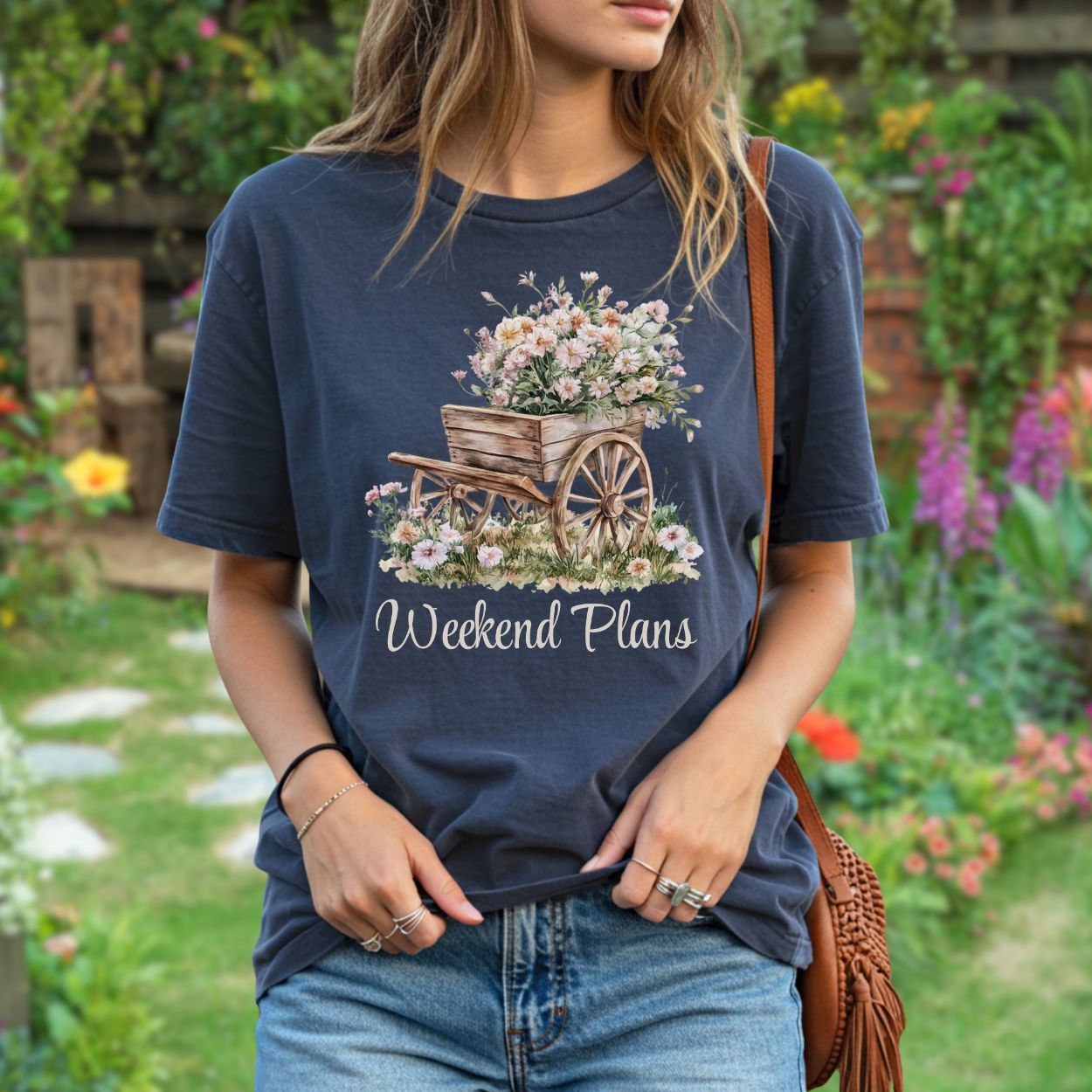 Relaxed-fit, garment-dyed navy t-shirt with a rustic gardening wagon overflowing with carnations and "Weekend Plans" text.