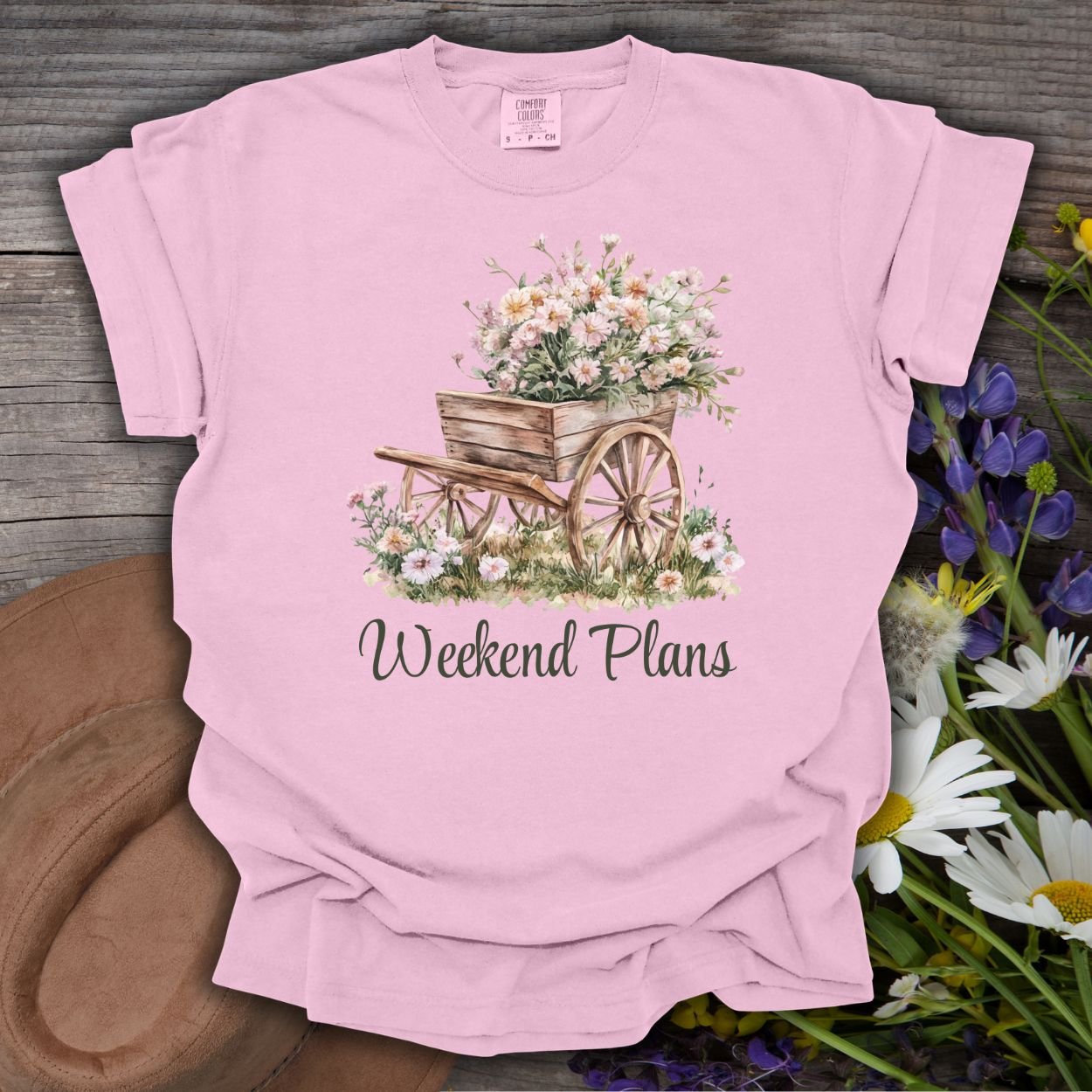Blossom pink garment-dyed cotton t-shirt with a watercolor rustic gardening wagon and "Weekend Plans" text.