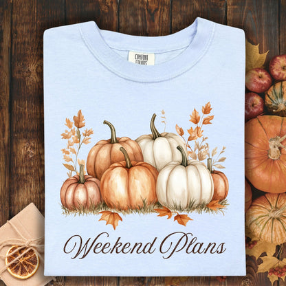 Hydrangea heavyweight cotton t-shirt with watercolor pumpkins and "Weekend Plans" text, surrounded by fall decor.