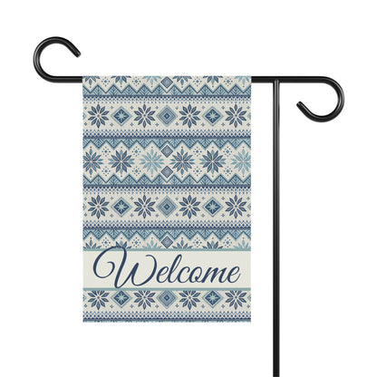 Blue Fair Isle pattern garden flag with "Welcome" in script, on a black metal stand.
