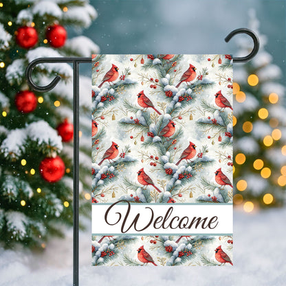 Watercolor cardinal garden flag with snowy evergreens, red berries, and "Welcome" script.