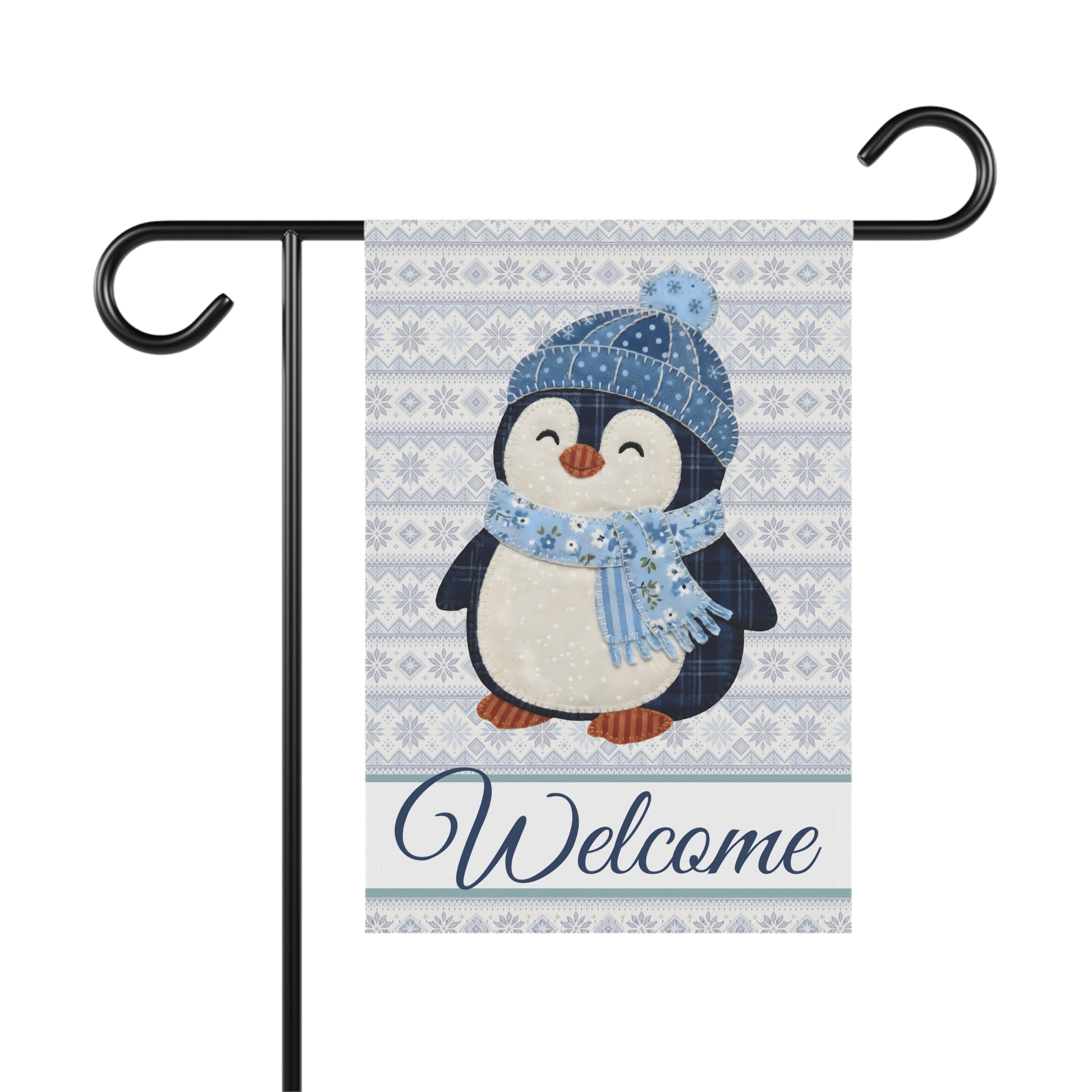 Fair Isle patchwork penguin garden flag with "Welcome" script, blue hat and scarf, on a black stand.