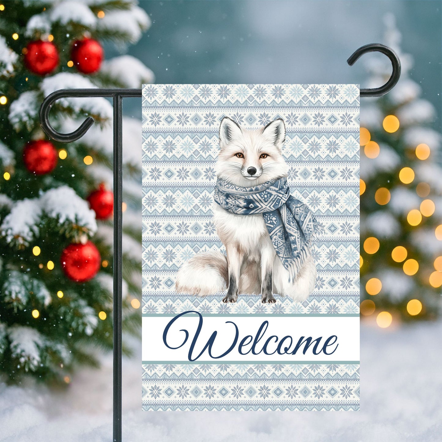 Winter fox garden flag with Fair Isle pattern, "Welcome" text, and a white fox wearing a blue scarf.