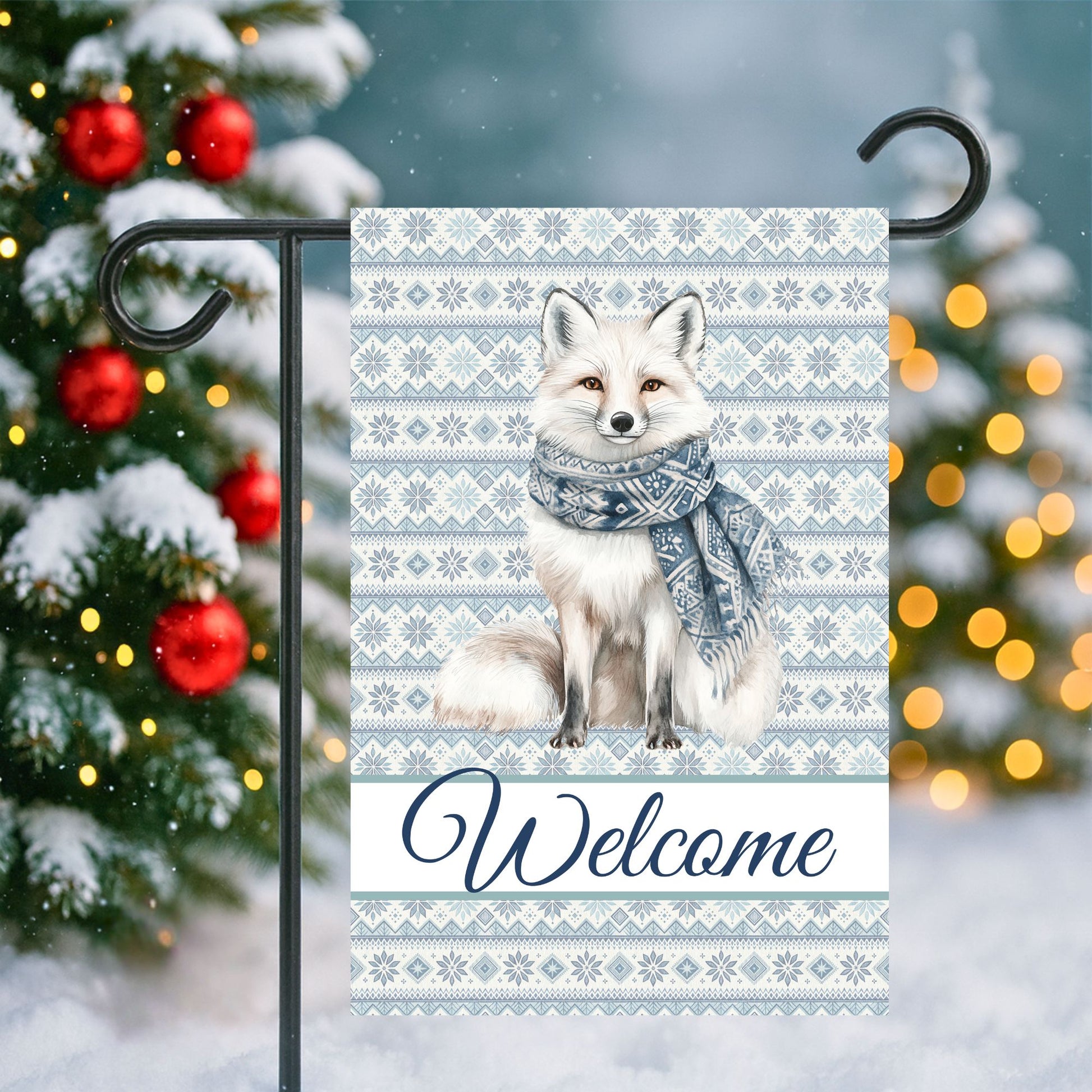 Winter fox garden flag with Fair Isle pattern, "Welcome" text, and a white fox wearing a blue scarf.