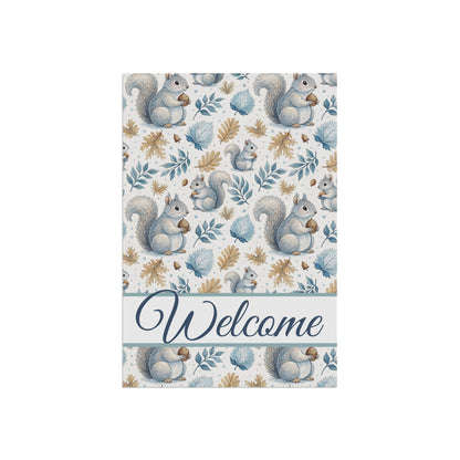 Watercolor garden flag with gray squirrels holding acorns, blue and gold leaves, and "Welcome" script.
