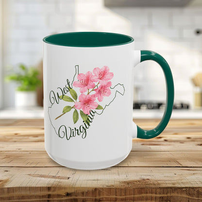 15oz white ceramic mug with green handle/interior, featuring a West Virginia silhouette and pink rhododendron.