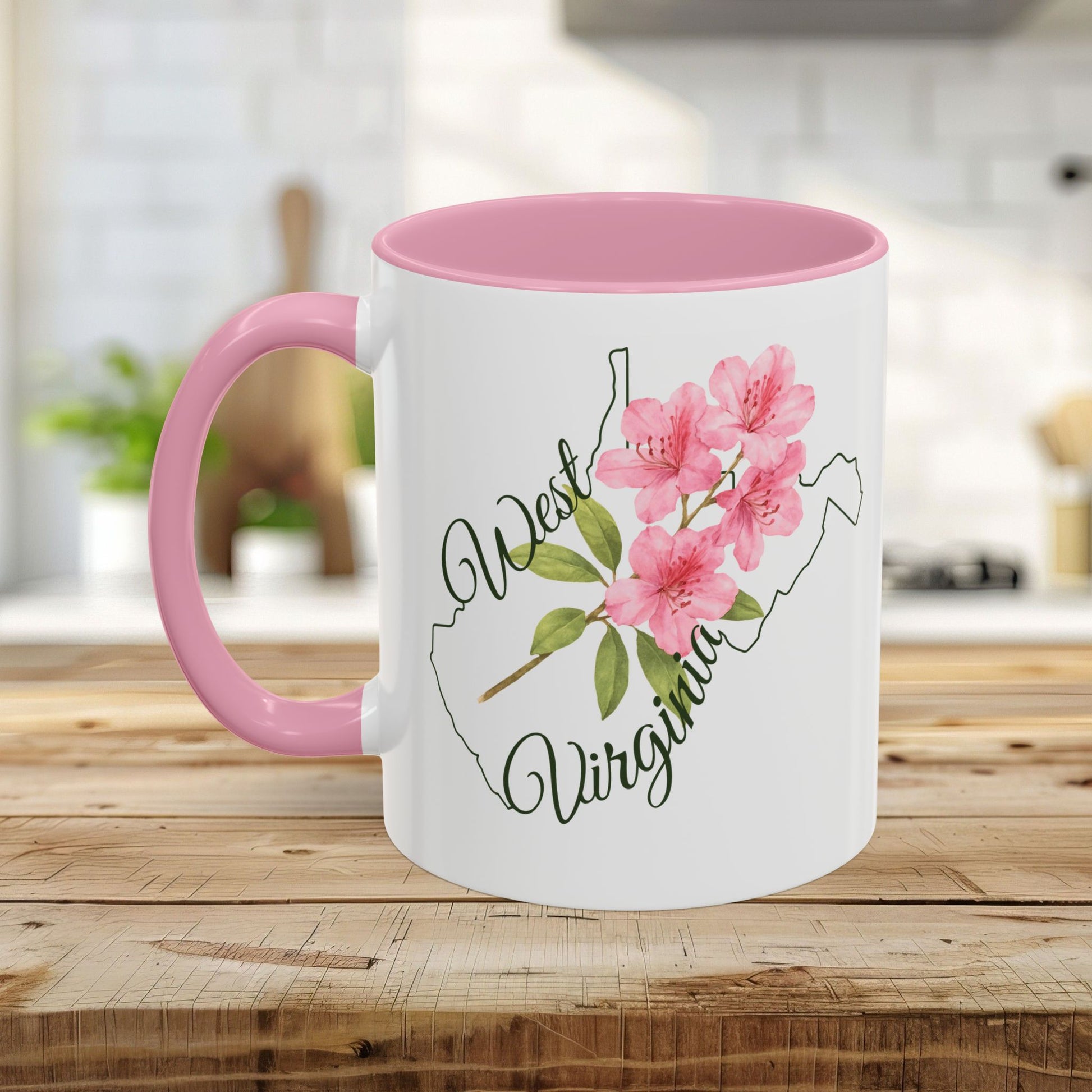 White ceramic mug with pink handle and interior, featuring a watercolor West Virginia rhododendron design.
